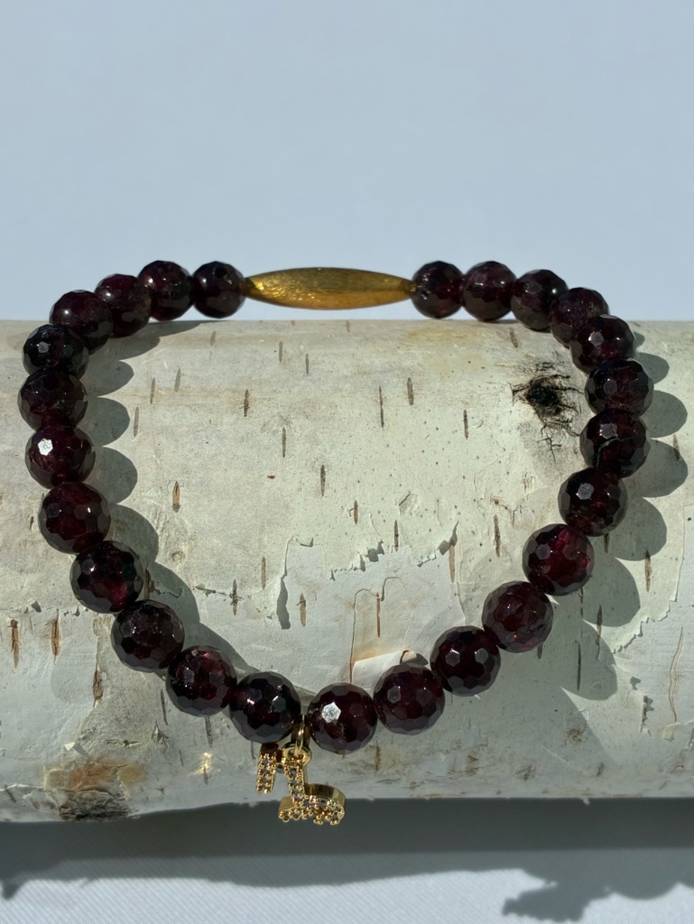 Faceted Garnet Bead Stretch Bracelet with Gold Accent and Zodiac Charm